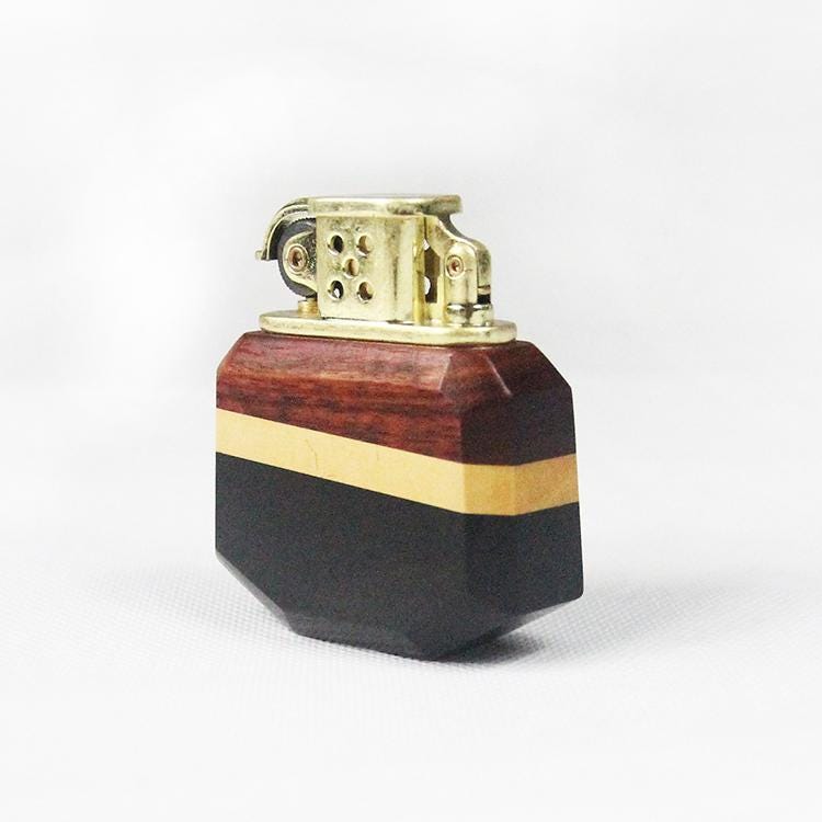 Lighter with wooden and gold accents on a white background