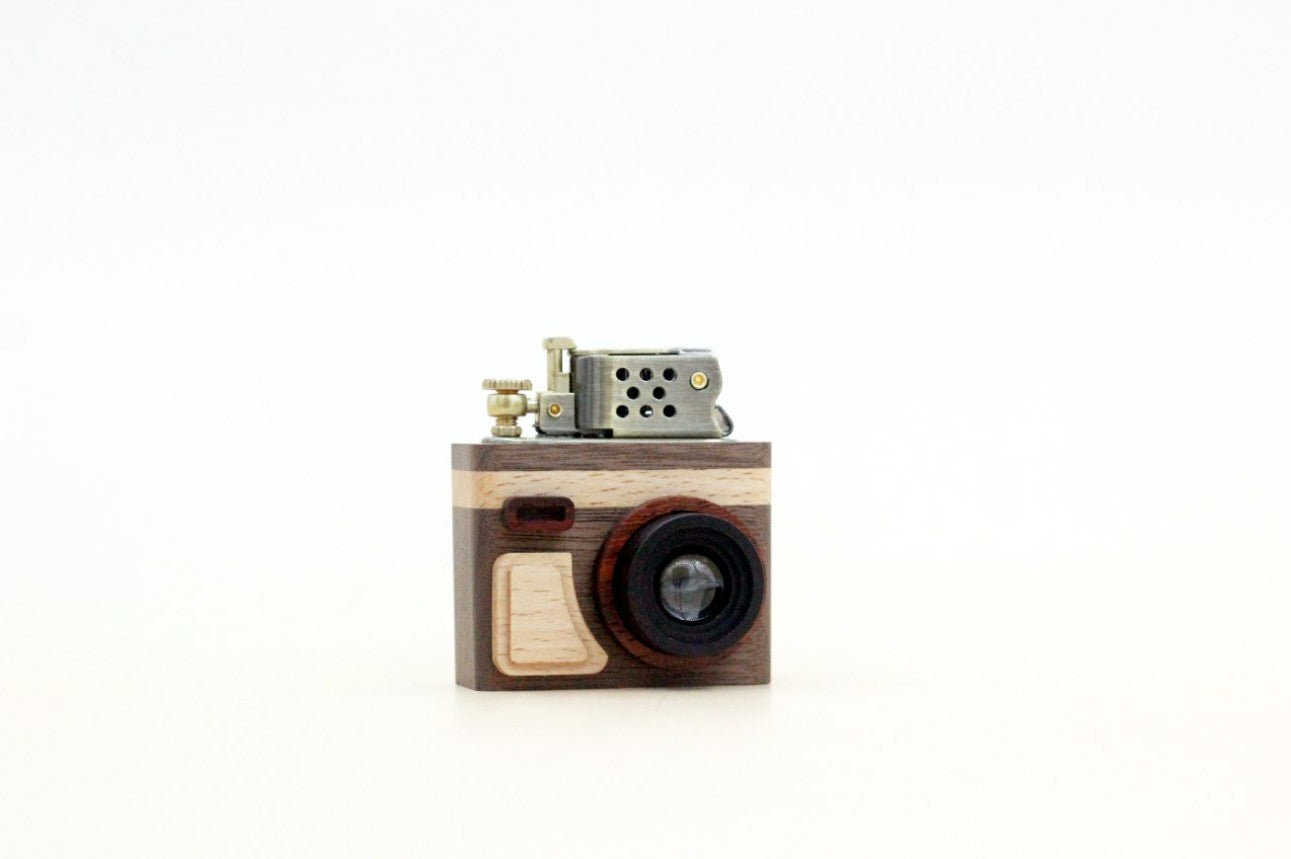 Wooden camera-shaped lighter on a white background