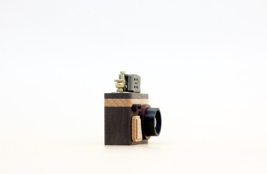 Small camera with wooden casing on a white background