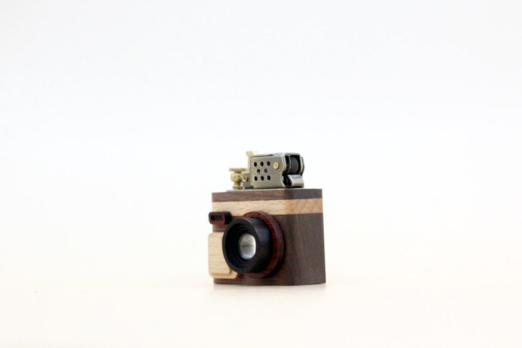 Wooden camera-shaped lighter on a white background