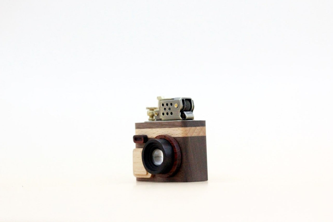 Wooden camera-shaped lighter on a white background