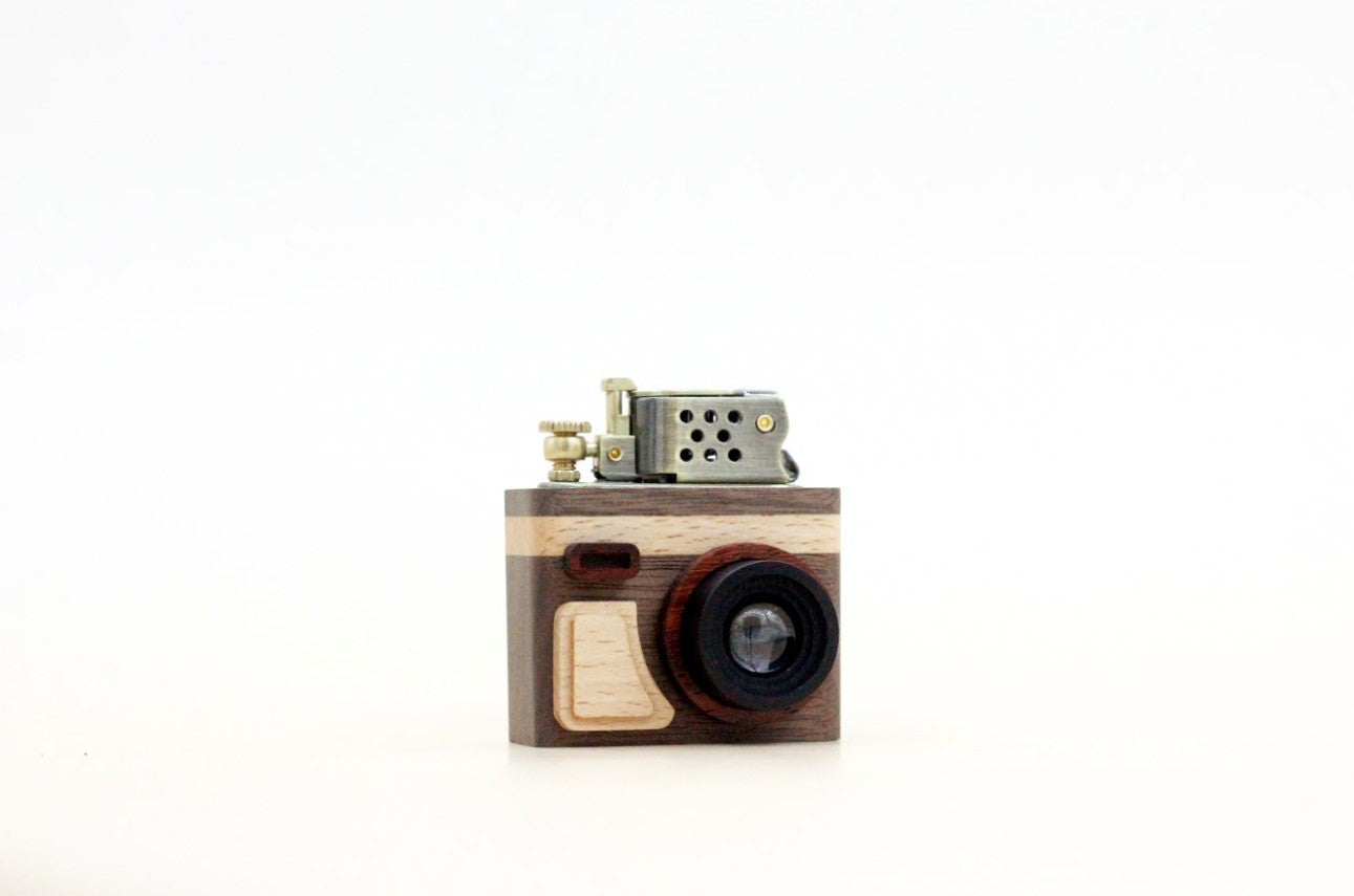Wooden camera-shaped lighter on a white background