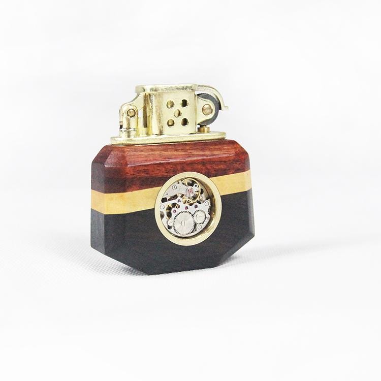 Decorative lighter with wooden and gold accents on a white background