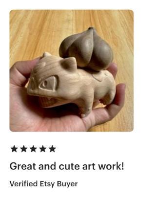 Wooden sculpture of a small animal held in a hand on a wooden surface, with a five-star rating and review text.