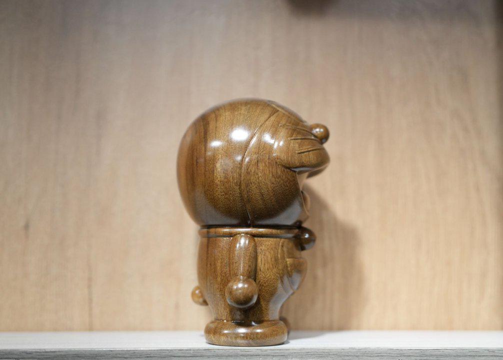Wooden sculpture of a character on a wooden surface