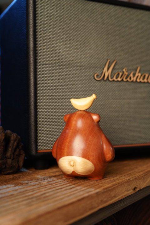 Wooden bear figurine with a banana 