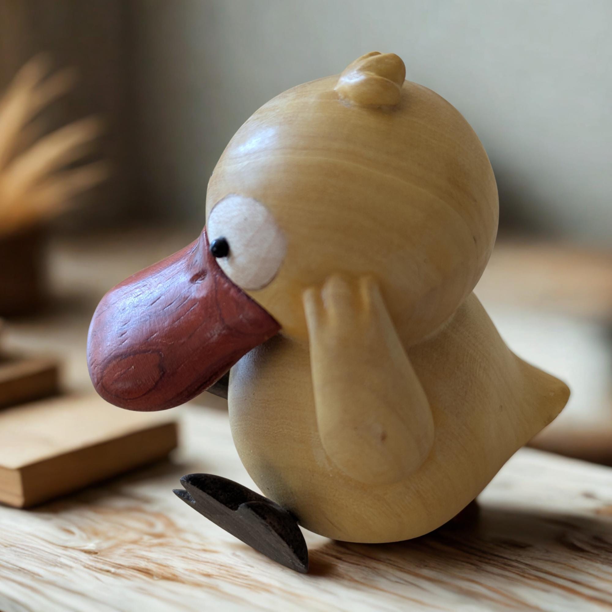 Wooden duck-shaped clip on a wooden surface