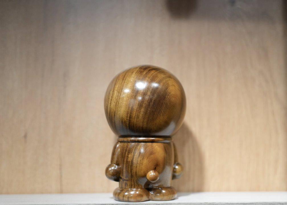Wooden figurine with a smooth finish on a wooden surface