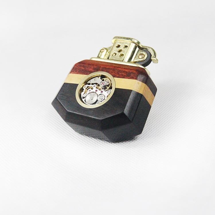 Decorative lighter with wooden and metallic design on a white background