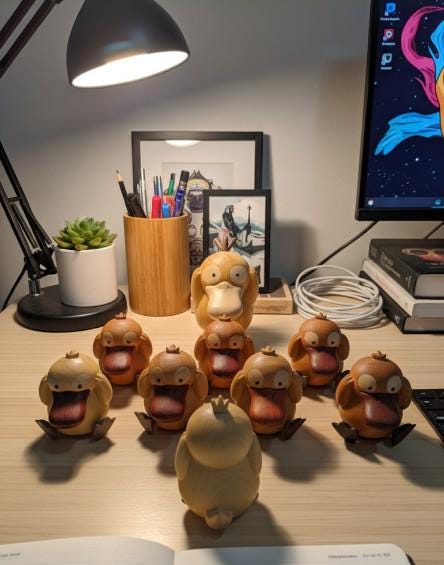 Collection of small brown psyduck figurines 