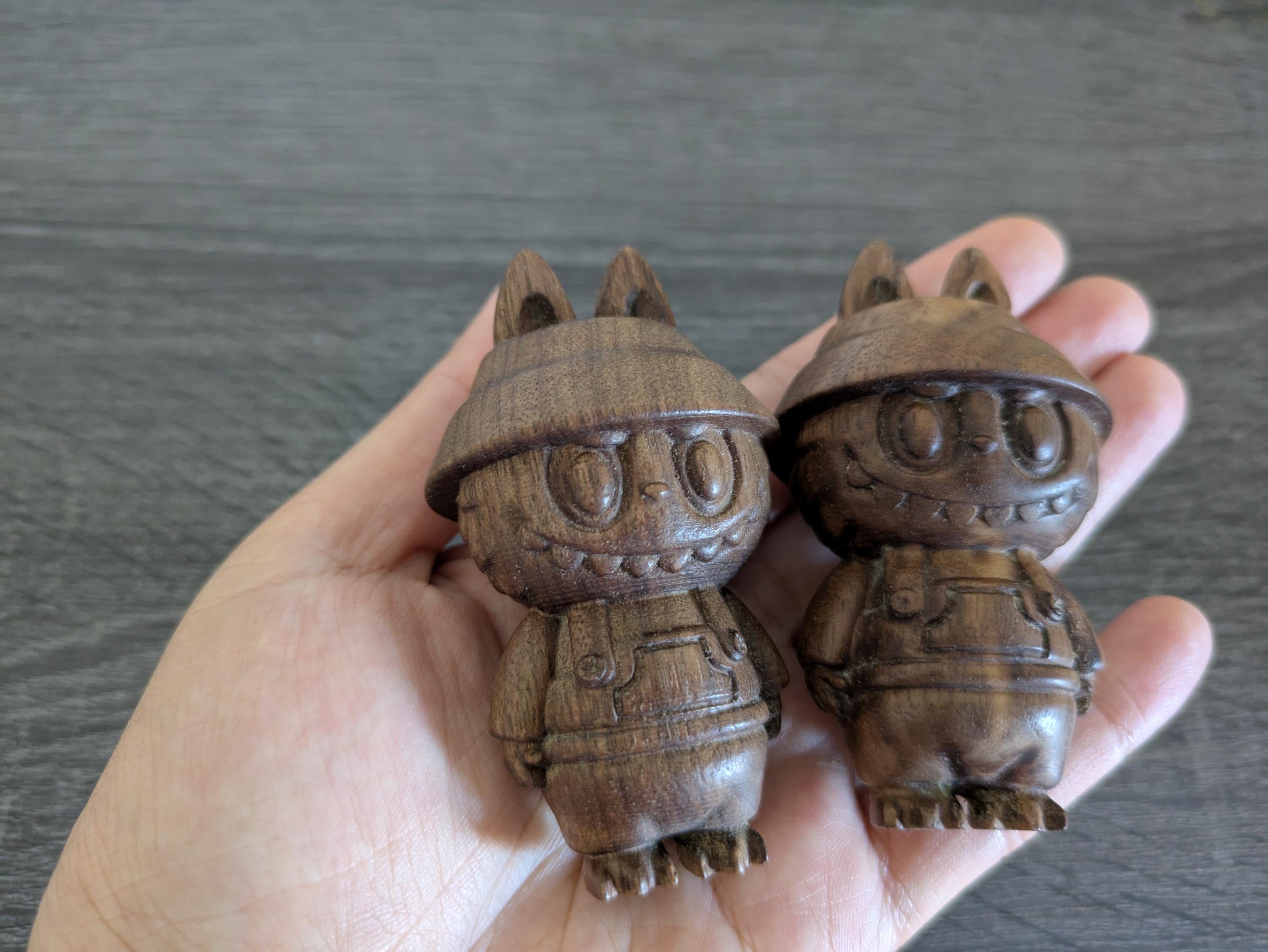 Two wooden little monesters figurines