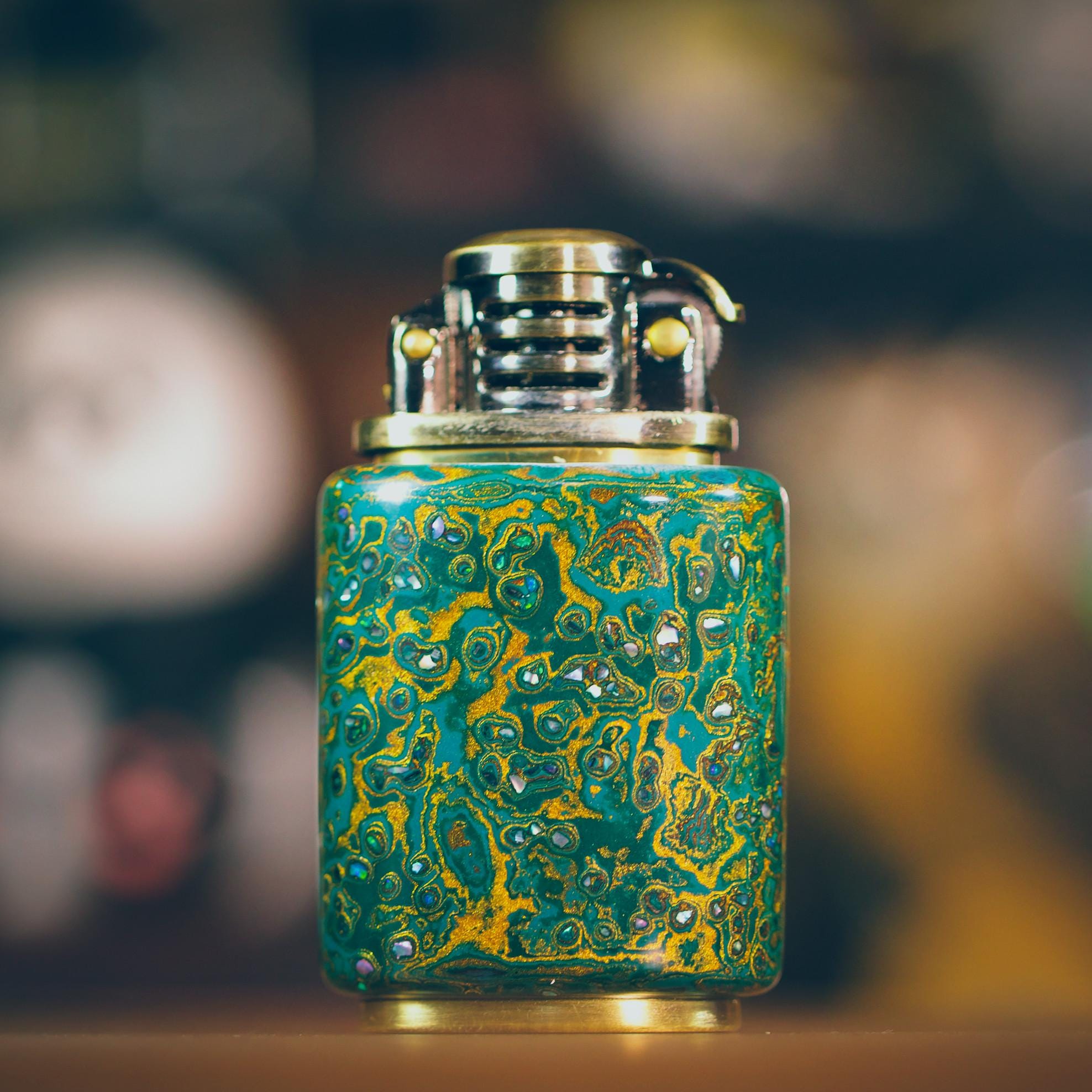 Decorative lighter with a green and gold marbled design 