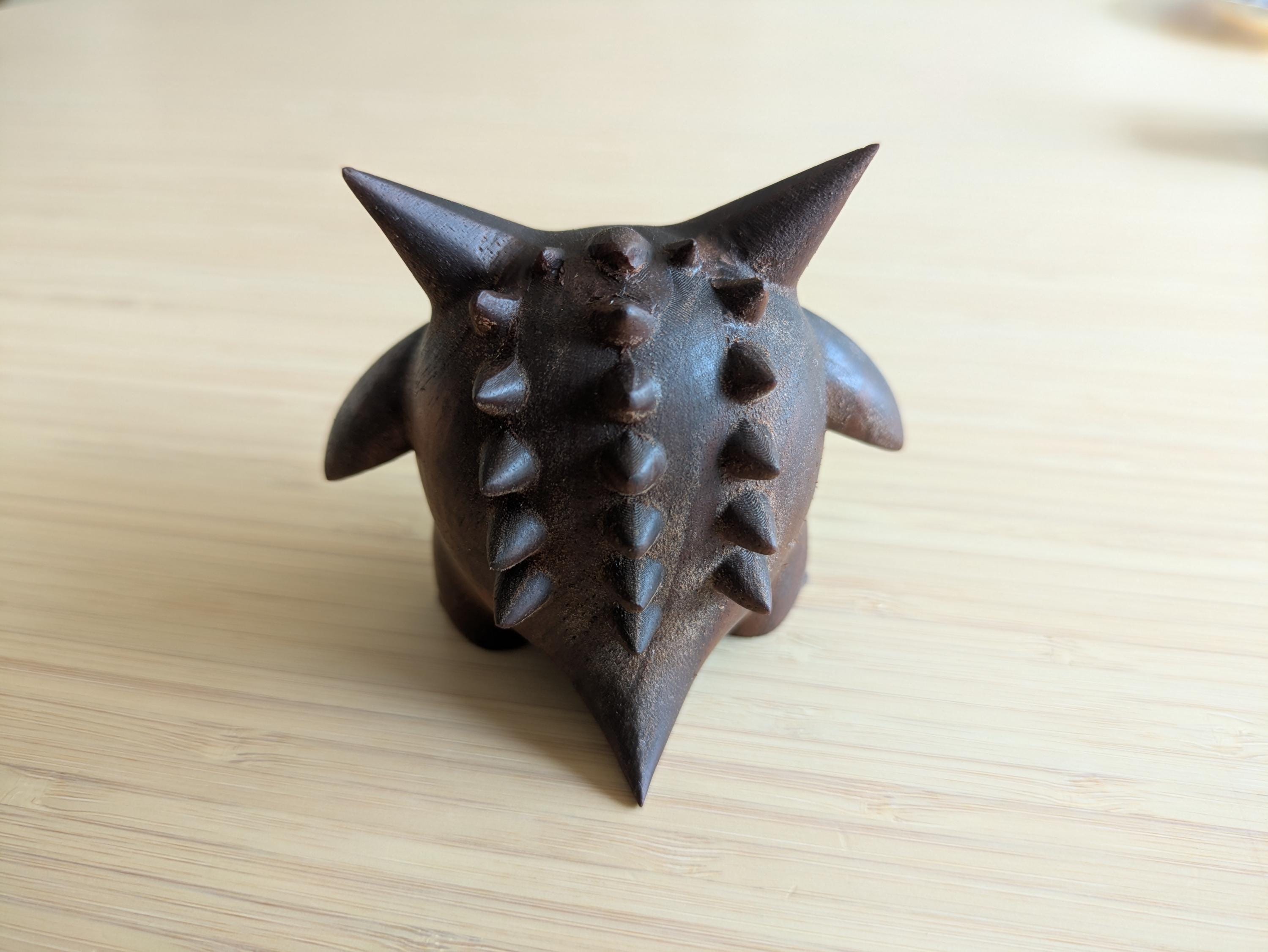 Dark brown object with spiky texture 