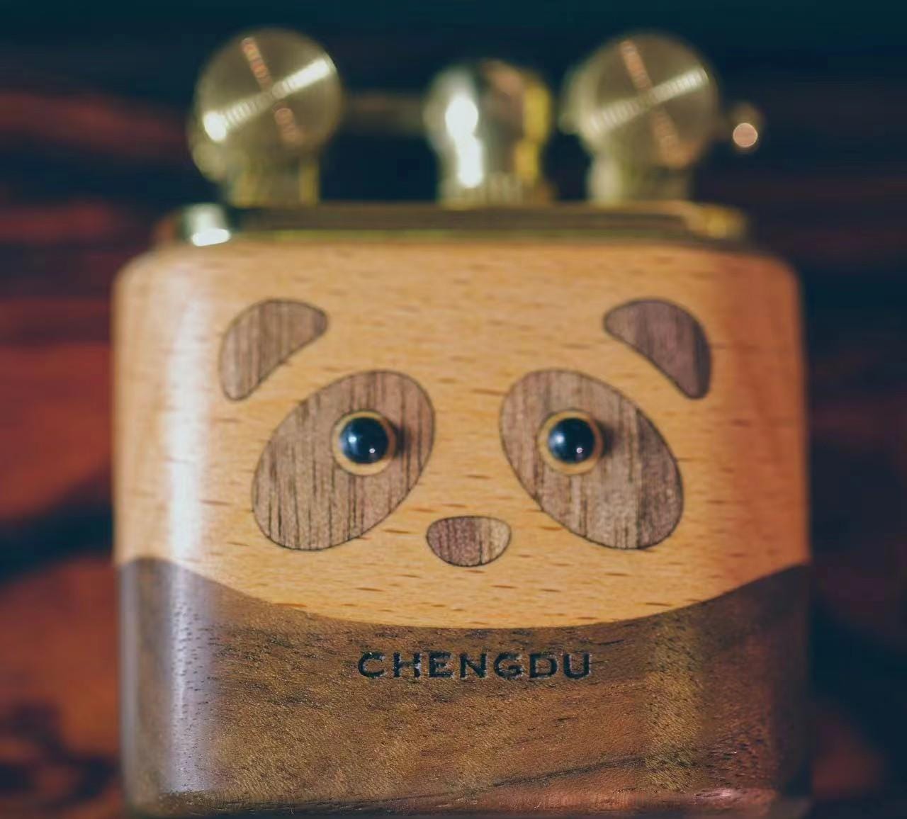 Wooden panda-shaped lighter with 'Chengdu' branding 