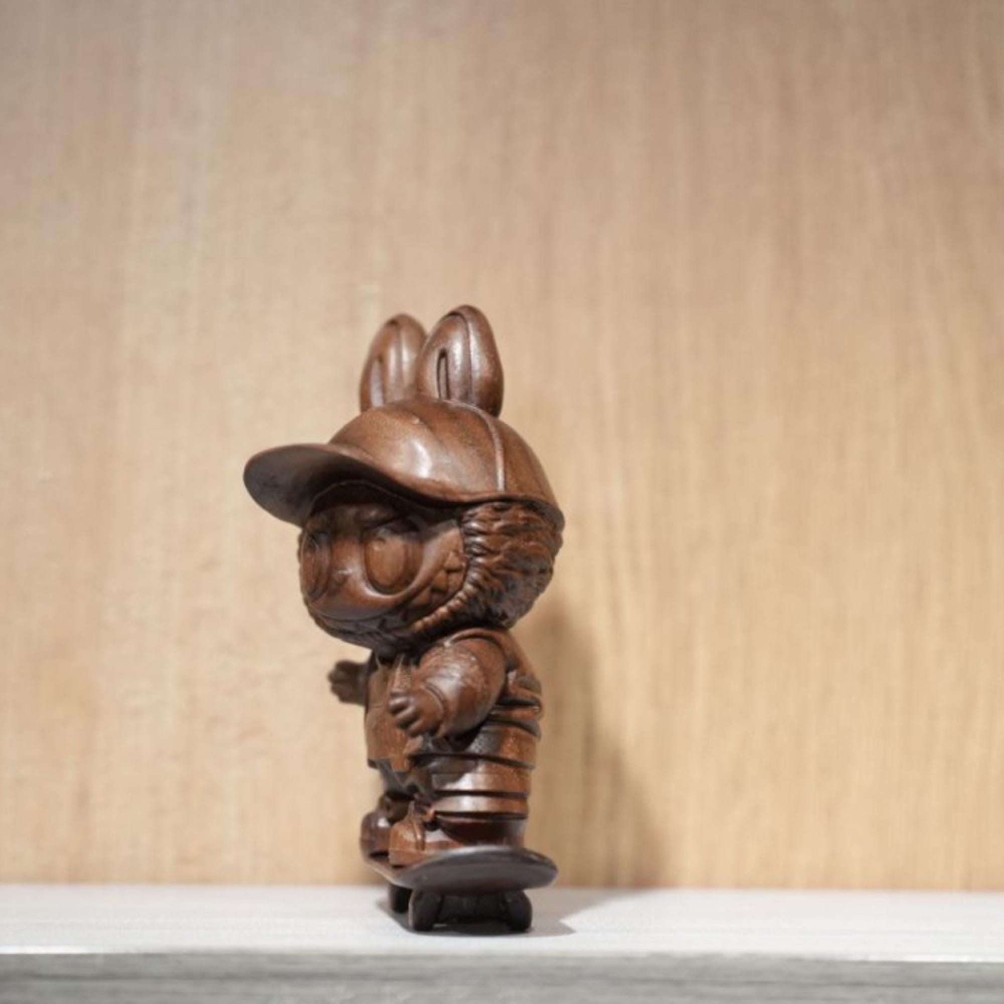 Wooden figurine of a character with a cap 